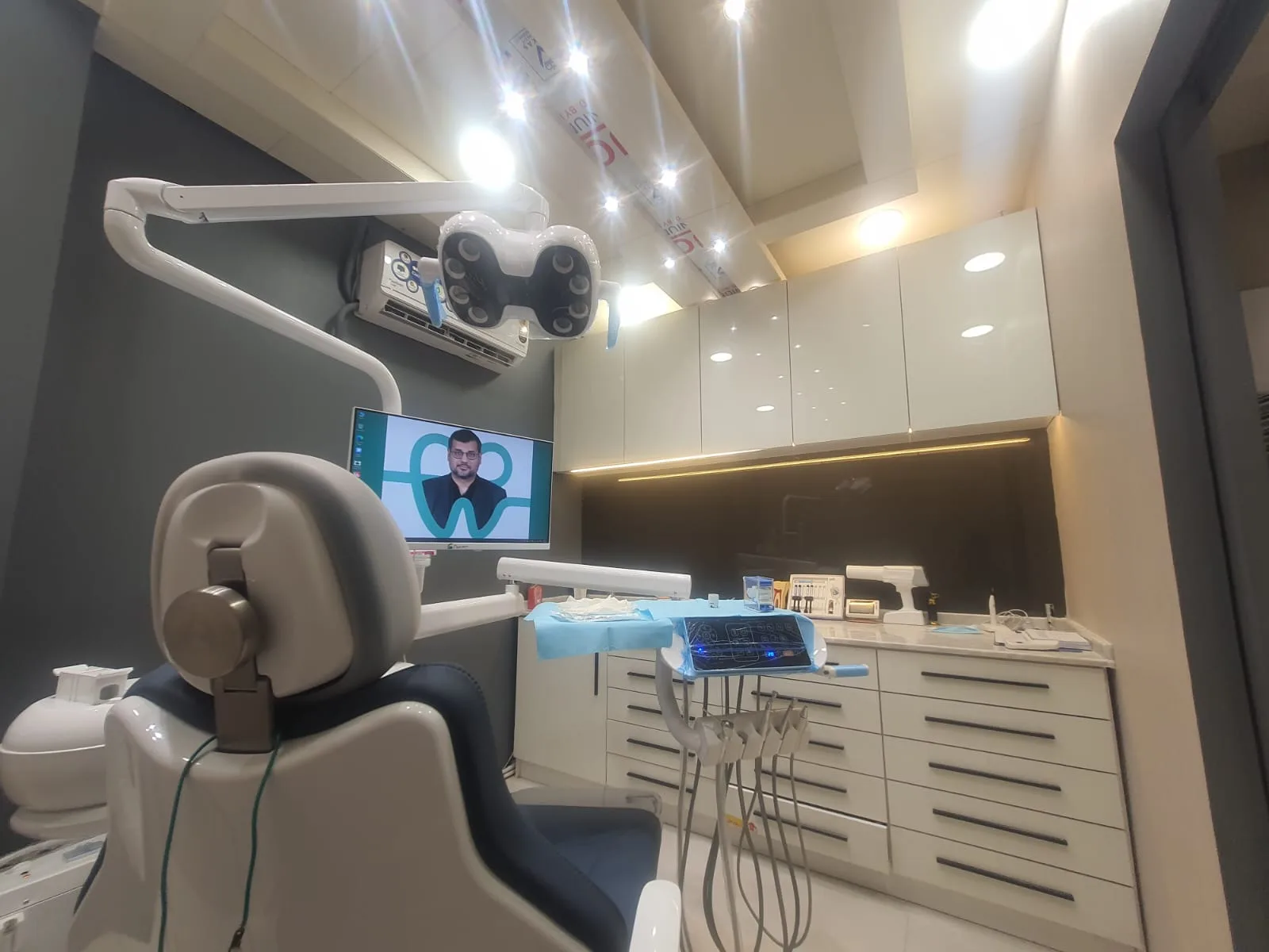 Treatment room at Clifton Block 9 with the dental chair, overhead light and chairside monitor