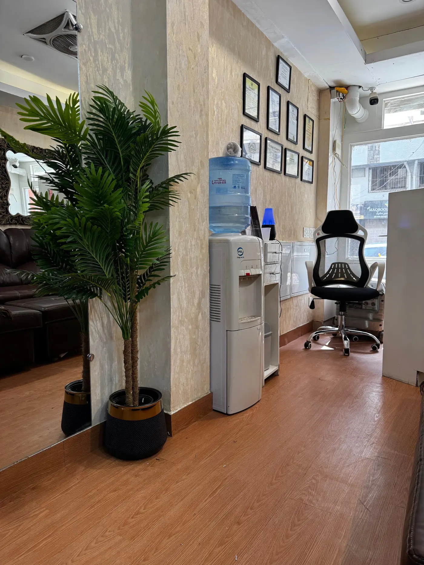Framed dental qualifications and certificates on display at the DHA Phase 5 clinic reception