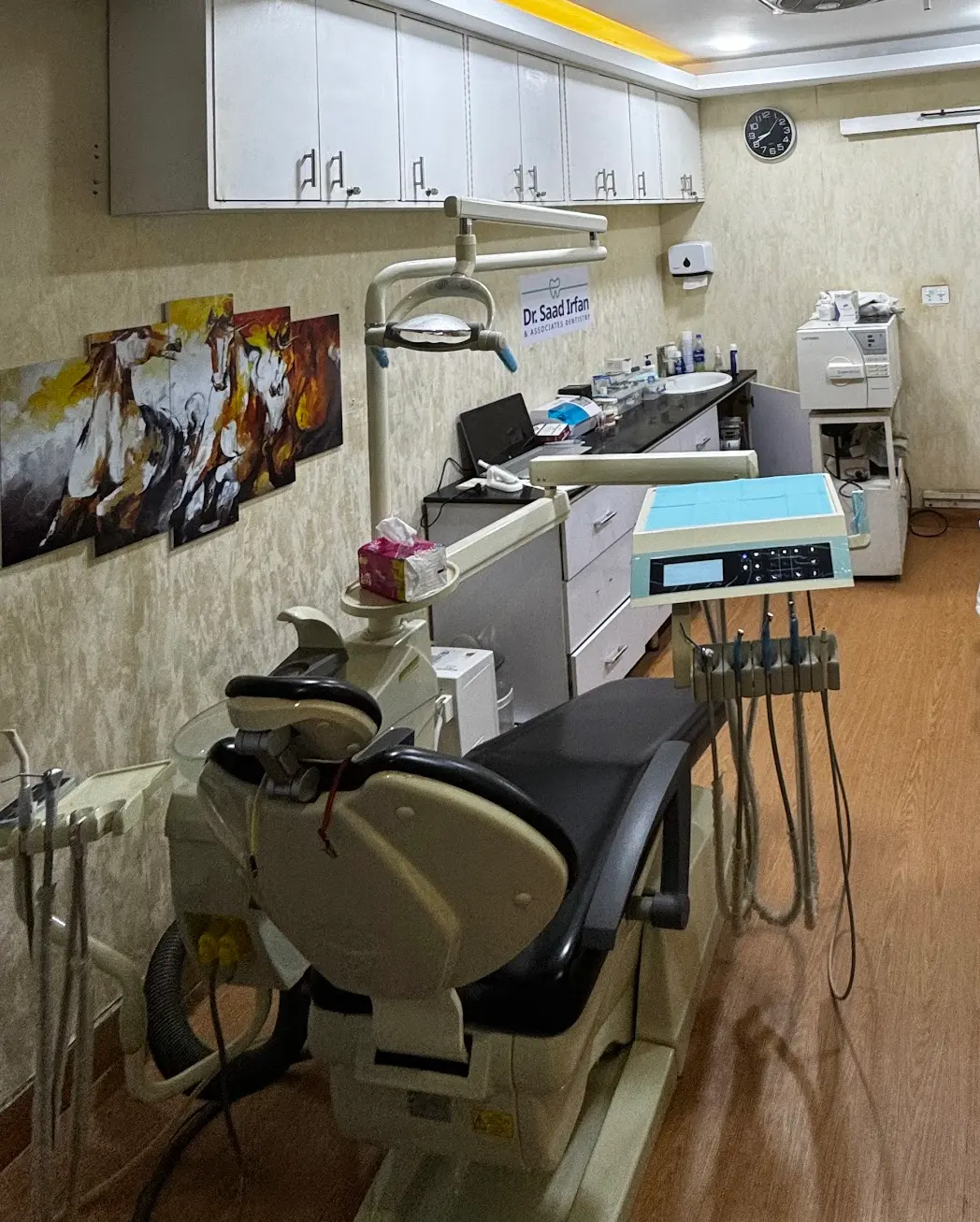 Treatment room at the DHA Phase 5 clinic showing the dental chair, worktop and autoclave