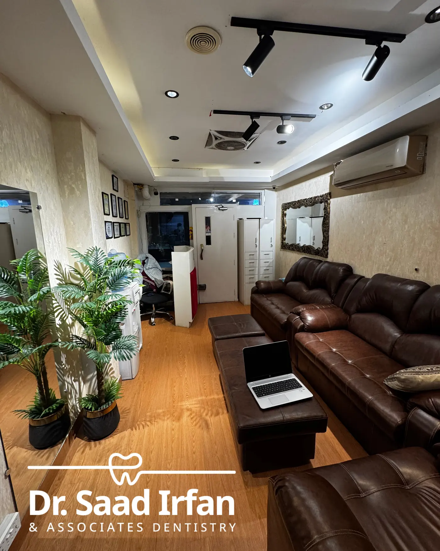 Patient waiting lounge at the DHA Phase 5 dental clinic, with seating and the framed qualifications wall